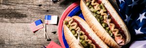 USA national holiday Labor Day, Memorial Day, Flag Day, 4th of July - hot dogs with ketchup and mustard on wood background, copy space