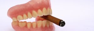 Cigar with dental prosthetic as anti smoking concept