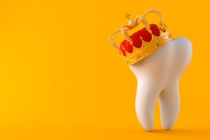 Tooth with crown isolated on orange background