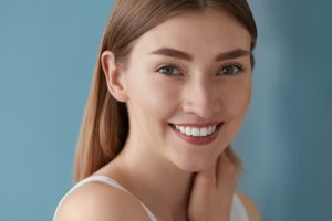Beauty portrait of smiling woman with white teeth smile. Beautiful happy girl with fresh skin, natural face makeup indoors closeup