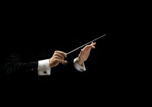 Hands of conductor on a black background