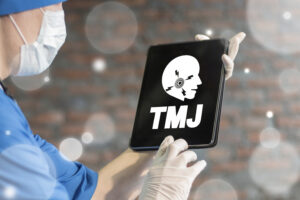 TMJ disease health care concept on laptop's display in doctor's