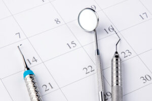 Reminder dentist appointment in calendar and professional dental tools.- Image