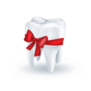 tooth with red bow on white background