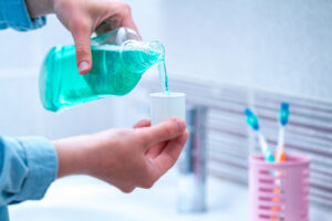 Oral hygiene, use of mouthwash for the health of teeth and gums. Fresh breath. Teeth care. Treatment of dental problems