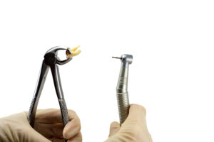 dental forceps and dental turbine tip decide to treat or remove tooth isolated on a white background