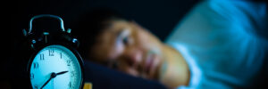 asian man in bed suffering insomnia and sleep disorder thinking