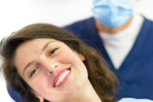 A happy young girl visiting her dentist