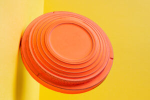 Clay disc target for skeet shooting flying against the colorful